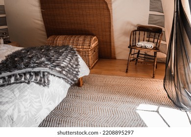 Calm And Quiet Room In A Tent Decorated With A Nice Vintage Wooden Chair And A Wicker Chest Next To The Bed