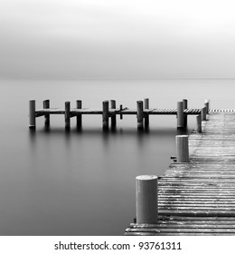 Calm scene in black and white with detail of wooden jetty