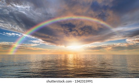 Calm Sea Before Storm With Amazing Rainbow At Sunset   