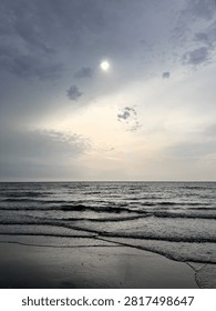 Calm sea beneath dramatic clouds moments before a storm. A coastal scene balancing serenity and anticipation as weather conditions begin to change.