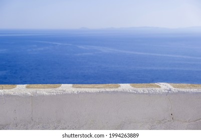 Calm sea, clear blue sky, view over a white stone parapet wall. Spectacular view to Aegean Sea, Cyclades Greece. Folegandros island outlook terrace. Copy space, summer vacations card template - Shutterstock ID 1994263889
