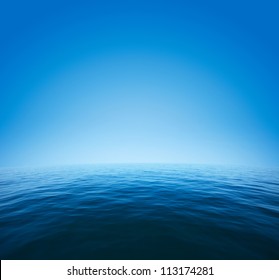Calm sea with distorted surface and blue clear sky