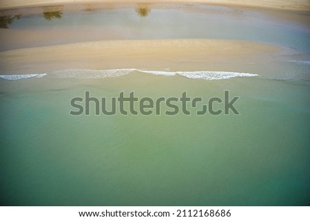 Similar – Luftpanorama-Drohne Blick auf die Meereswellen, die am felsigen Strand erdrücken.