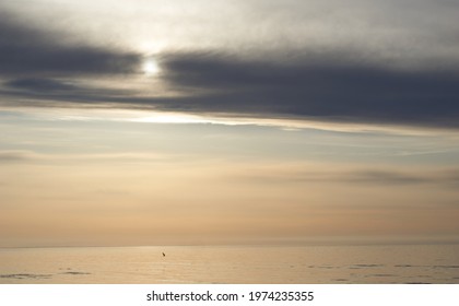 Calm Sea With Sunset Sky And Sun Through The Clouds Over. Meditation Ocean And Sky Background. Tranquil Seascape. Horizon Over The Water. High Quality Photo