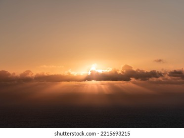 Calm Sea With Sunset Sky And Sun Through The Clouds. Tranquil Landscape And Horizon Over The Water. High Quality Photo