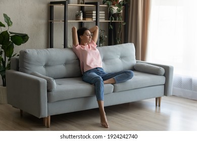 Calm Serene Pretty Arabian Woman Rest Relax On Couch At Home Breath Fresh Air Meditate Enjoy Free Time On Weekend. Peaceful Young Indian Lady Dreaming On Sofa At Modern Living Room Nap Relieve Stress