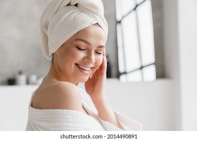 Calm Serene Young Woman In Spa Bathrobe And Towel Relaxing After Taking Shower Bath With Her Eyes Closed At Home. Beauty Treatment Concept. Body Skin And Hair Care