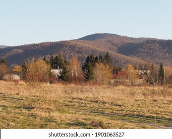 Calm Silesian Beskid Mountains range seen from sport airfield in european Bielsko-Biala city in Poland, clear blue sky in 2020 warm sunny spring day on April at sun set.