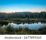 Calm sunset reflection on Snake River in Grand Teton National Park, Wyoming, USA.