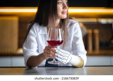 Calm Thoughtful Girl Holds Glass Of Wine In Bionic Arm At Home, Woman With Artificial Prosthetic Limb