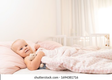 Calm Toddler Girl In Bed Getting Ready For Bed With A Toy.