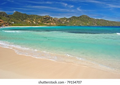 Calm Tropical Beach With Mountains On Union Island