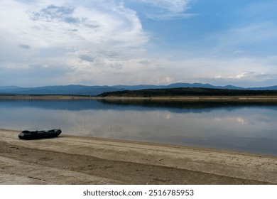 Calm water on a dam and a boat ready for fishing - Powered by Shutterstock