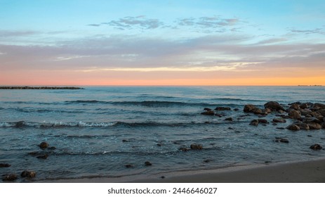 Calm Waves crash on shore during a beautiful sunset off the coast of Spain, Valencia, Spanish Coast, Beach Sunset, Rocky Coastline, Calm Energy, Horizon, European Vacations - Powered by Shutterstock