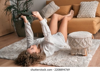 Calm woman enjoying story in book at home - Shutterstock ID 2208894769