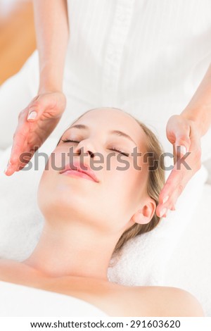 Similar – Young blond woman receiving a head massage