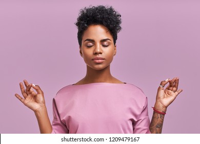 Calm woman relaxing meditating, no stress free relief at work concept, mindful peaceful young businesswoman or student practicing breathing yoga exercises on isolated over lavender background - Shutterstock ID 1209479167
