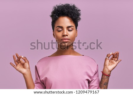 Calm woman relaxing meditating, no stress free relief at work concept, mindful peaceful young businesswoman or student practicing breathing yoga exercises on isolated over lavender background