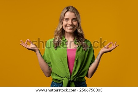 Similar – Pretty woman with OKAY sign, ok gesture. Happy lady, correct choice, yellow wall