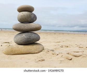 Calming Stacked Rocks On A Beach.