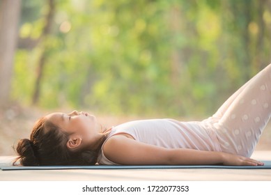 calmness and relax, female happiness.Horizontal, blurred background. little asian girl meditates while practicing yoga. freedom concept. calmness and relax, child happiness. toned picture healthy life - Powered by Shutterstock