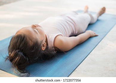 calmness and relax, female happiness.Horizontal, blurred background. little asian girl meditates while practicing yoga. freedom concept. calmness and relax, child happiness. toned picture healthy life - Powered by Shutterstock