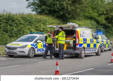 Calne Wiltshire UK May 22 2020 A Police Collision Investigation Unit Van With Its Rear Open And 2 Officers Standing Next To 2 Police Cars In A Coned Of Section Of Road