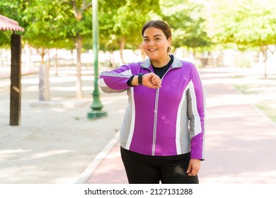 Calorie Counting App. Attractive Big Woman Using Her Smartwatch And Smiling After Her Cardio Workout