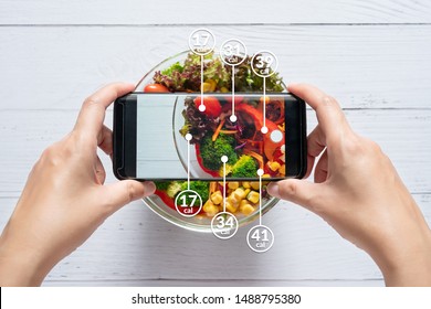 Calories counting and food control concept. woman using application on smartphone for scanning the amount of calories in the food before eat - Shutterstock ID 1488795380