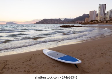 Calpe Alicante sunset at beach Cantal Roig in Mediterranean Spain with paddle sufboard