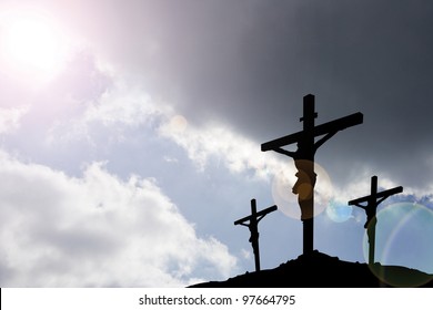 calvary crucifixion with dark sky and rays of light