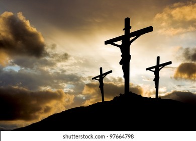 calvary crucifixion with sun setting behind