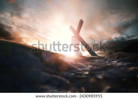 Calvary Golgotha Hill red sky, bright light and Jesus carrying the cross symbolizing pain and trials, death and resurrection, Passion Week background
