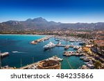 Calvi historic city center with sandy beach, historic houses and harbor with boats and yachts, Corsica, France, Europe. 