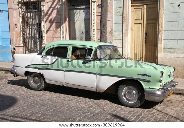 CAMAGUEY, CUBA -\
FEBRUARY 17, 2011: Classic Oldsmobile car parked in the street in\
Camaguey, Cuba. Cuba has one of the lowest car-per-capita rates (38\
per 1000 people in\
2008).