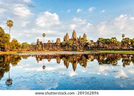 Cambodian landmark Angkor Wat with reflection in water on sunset. Siem Reap, Cambodia