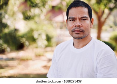 Cambodian man  Wearing a white t-shirt looking at the camera. Without retouching. That is his real face. - Shutterstock ID 1888293439