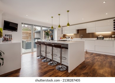 Cambridge, England - April 29 2019: Modern Kitchen With Peninsular Breakfast Bar And Bifold Doors.