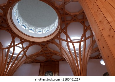 Cambridge, England - July 20th 2022: Modern Cambridge Eco Mosque interior timber structures and main male prayer area with intricate mimbar for the imam to perform prayer.