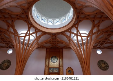 Cambridge, England - July 20th 2022: Modern Cambridge Eco Mosque interior timber structures and main male prayer area with intricate mimbar for the imam to perform prayer.