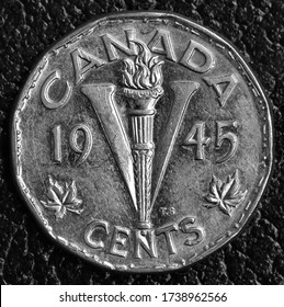 Cambridge, Ontario / Canada - May 22 2020 : Showing A 1945 Victory Nickel. Morse Code Around The Rim Edge And Many Scratches From Years Of Circulation.