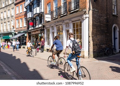 Cambridge, UK -April 2018. Young Students Cycling In Trinity Street, Central Cambridge, UK