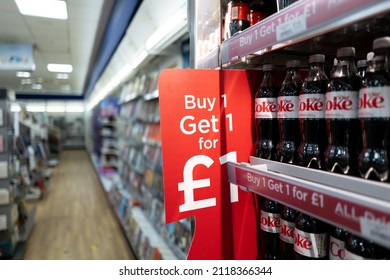 Cambridge, UK - Circa January 2022: Very Shallow Focus Of A Buy 1 Red Sign Seen At A Cold Drinks Chiller In A Well Known High Street Store. Bottles Of Cold Beverages Are Seen Within The Chiller.