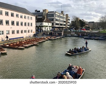 Cambridge, UK - Circa May 2019: Tourists punting on the River Cam in spring. Punting is a popular tourist activity in Cambridge.