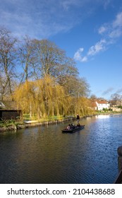Cambridge, UK - January 7 2022: Tourists punting on the River Cam, Cambridge, England
