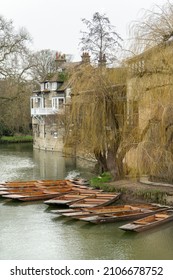 Cambridge, UK - January 7 2022: Moored up wooden punts at Mill Pond, Cambridge