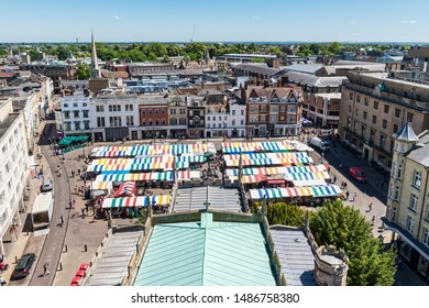 CAMBRIDGE, UK - JUNE 22, 2018: Aerial view of colourful market stalls in the Market Square in Cambridge, England.