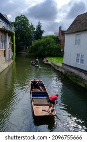 Cambridge, United Kingdom - August 1, 2021: Tourist punting on the river Cam, viewed from Magdalene bridge.