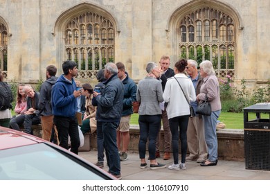 CAMBRIDGE, UNITED KINGDOM - MAY 30, 2018: Tourist Group Meet Their Tour Guide Outside Kings College