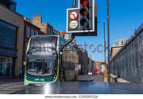 Cambridge University, England - March\
5, 2019: Cambridge\'s iconic double-decker\
bus